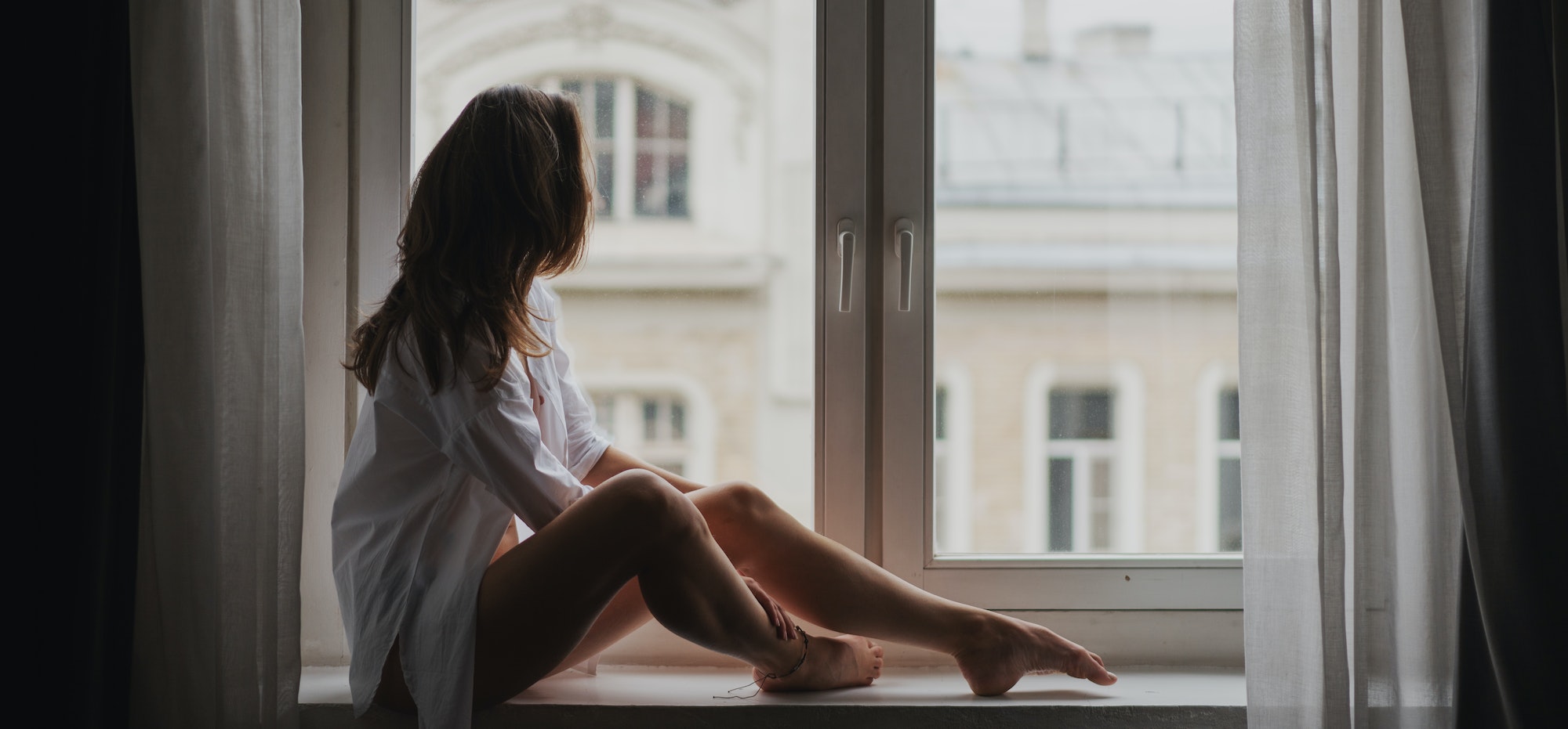 Young woman on windowsill